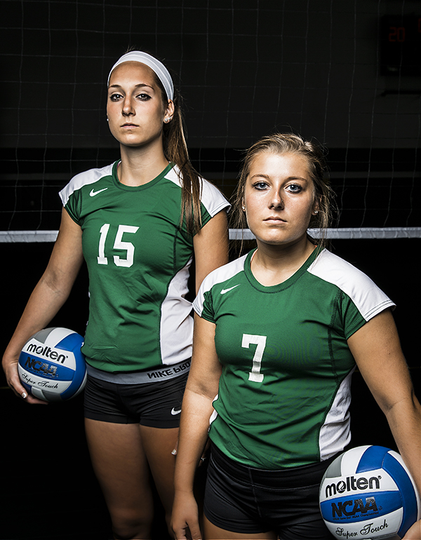 Women's Volleyball Team - two players posing by the net