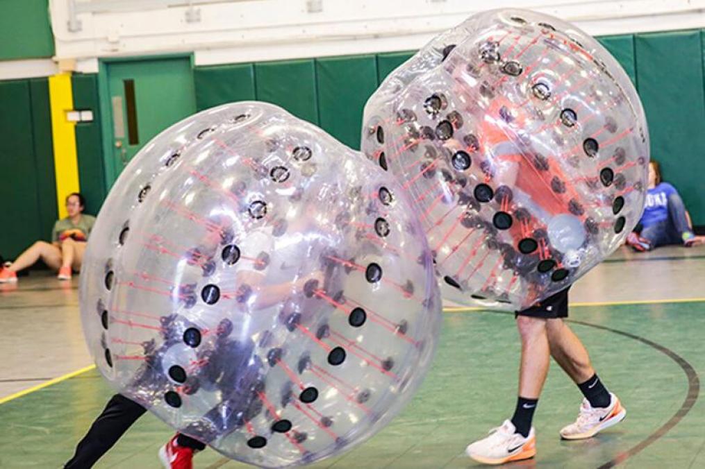 Students playing with large plastic bubbles