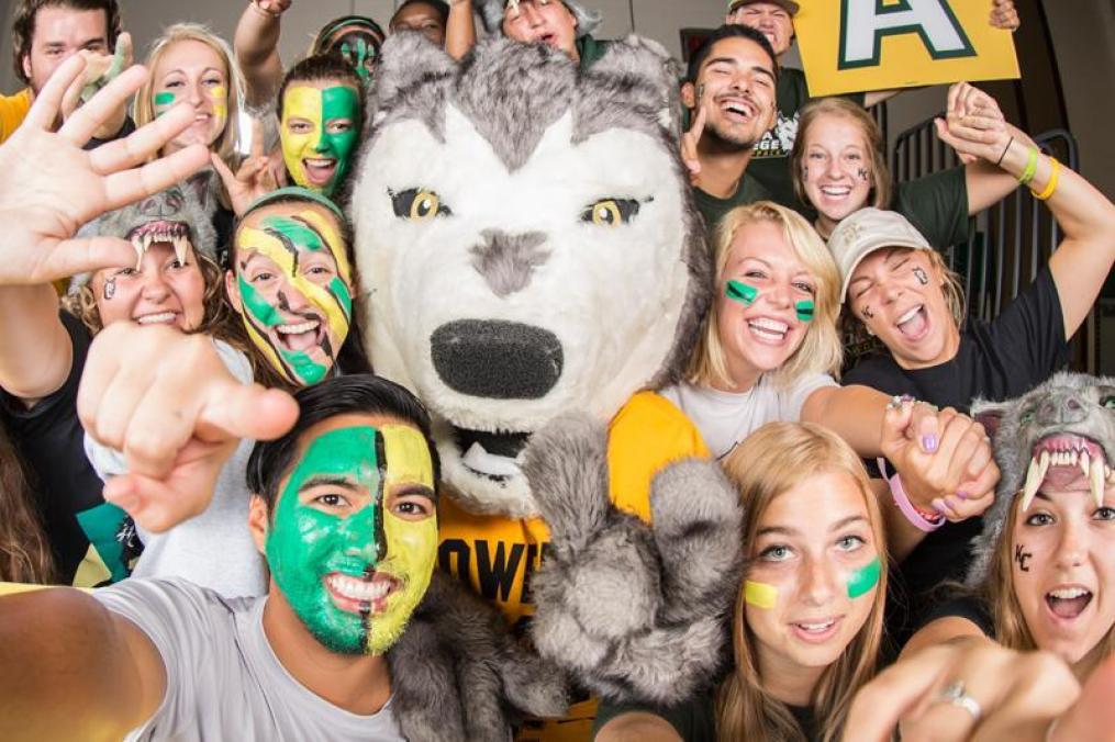 students gathered around the wolf mascot 