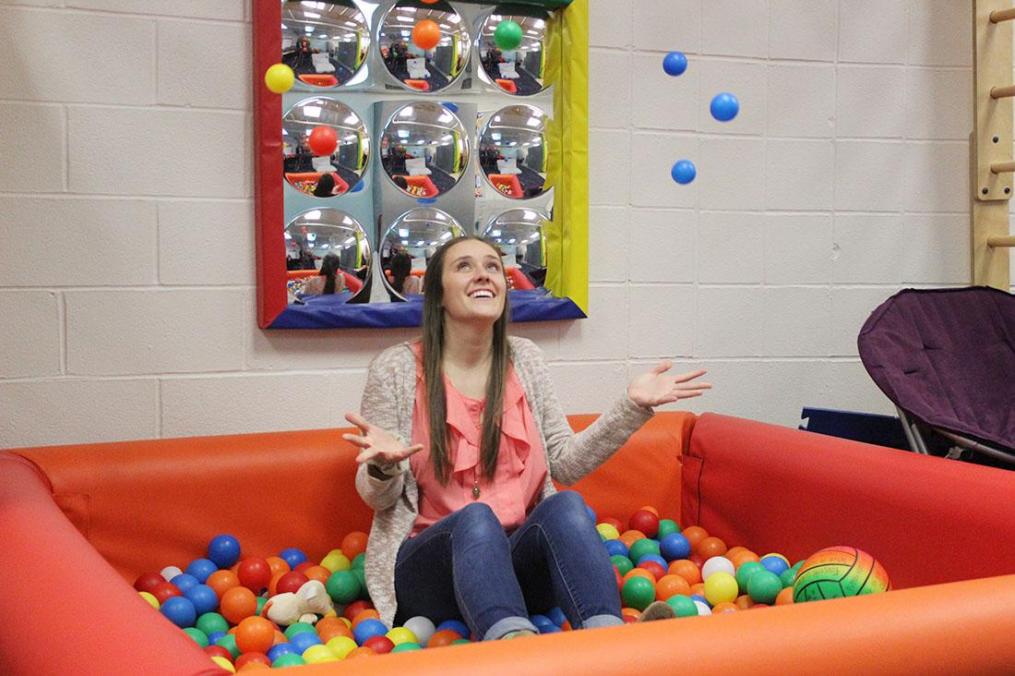 Martha Rinella '19 has a bit of fun in the ball pit inside the Division of Occupational Therapy's Pediatric Lab.