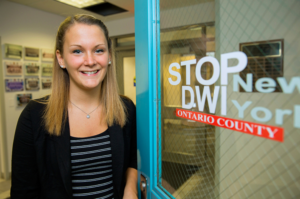 Brittany Heysler, a Criminal Justice degree graduate, outside of her internship with Ontario County.