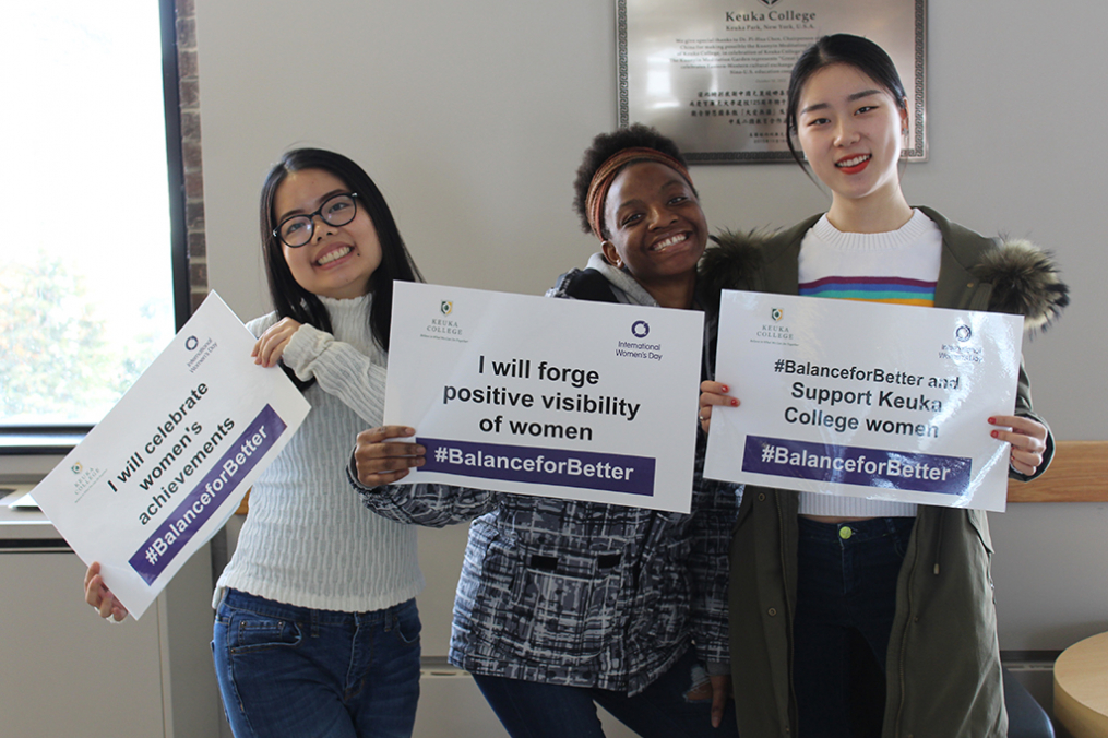 Keuka College students, from left, Belle Nguyen, Alice Nizerimana, and Qingwen Yao were among those commemorating International Women's Day on Friday, March 8. 