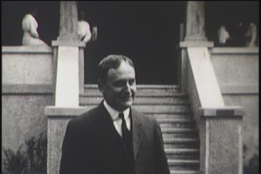 Rev. Joseph Serena black and white photo of him standing outside of a house