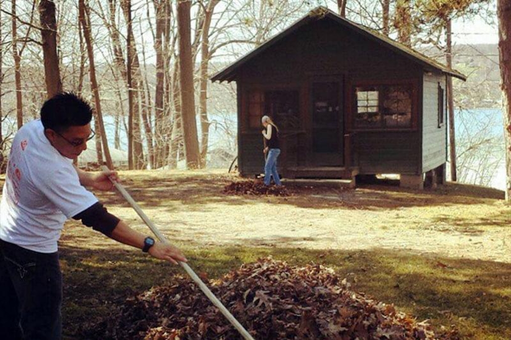 student raking leaves for the community