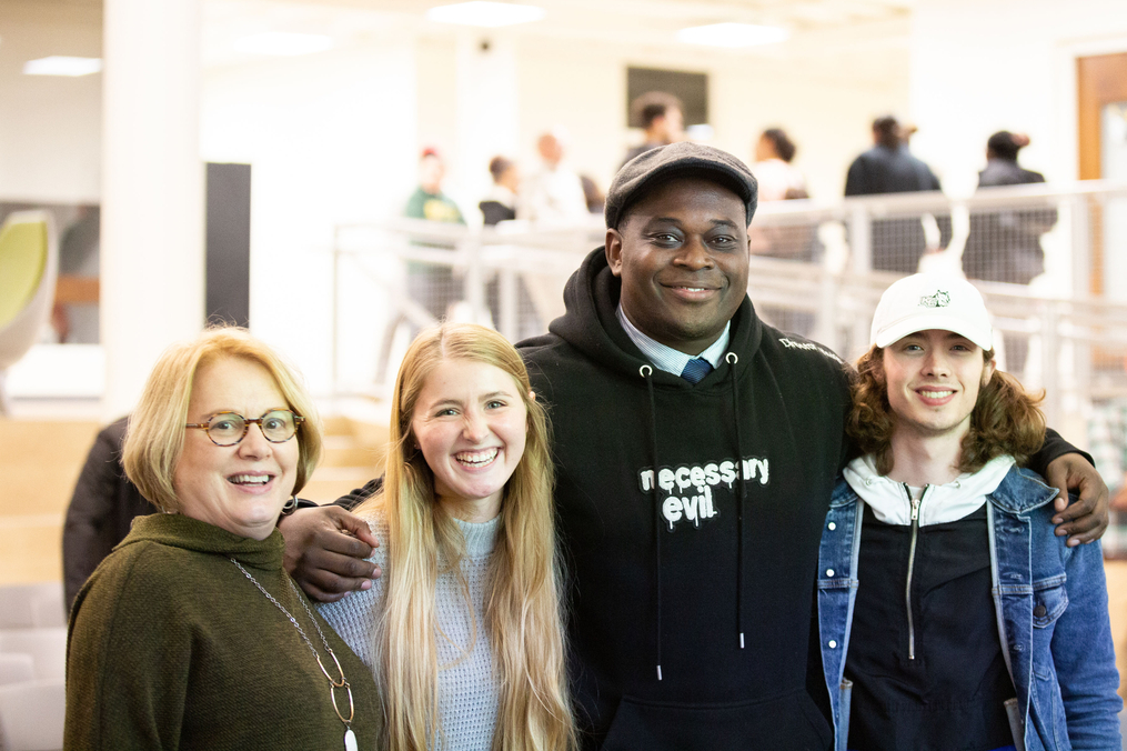 Filmmaker Jamal Hodge poses with Betty Lou Koffel '74 and students