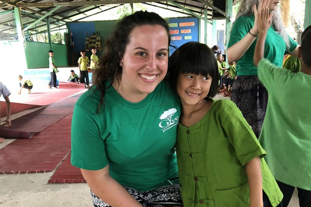 Sarah Honan '21 and one of the children she met during her summer Field Period® to Thailand.