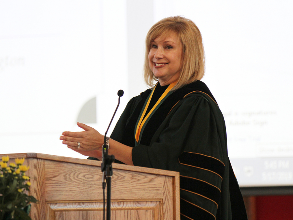 Keuka College President Amy Storey at a podium speaking