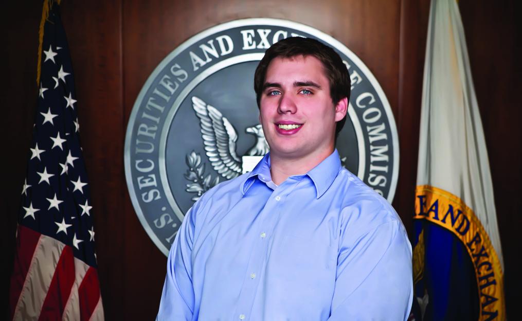 Dylan Campbell stands in front of the U.S. Securities and Exchange Commission seal.