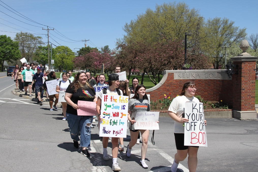 Students marching in peaceful demonstration at entrance of campus