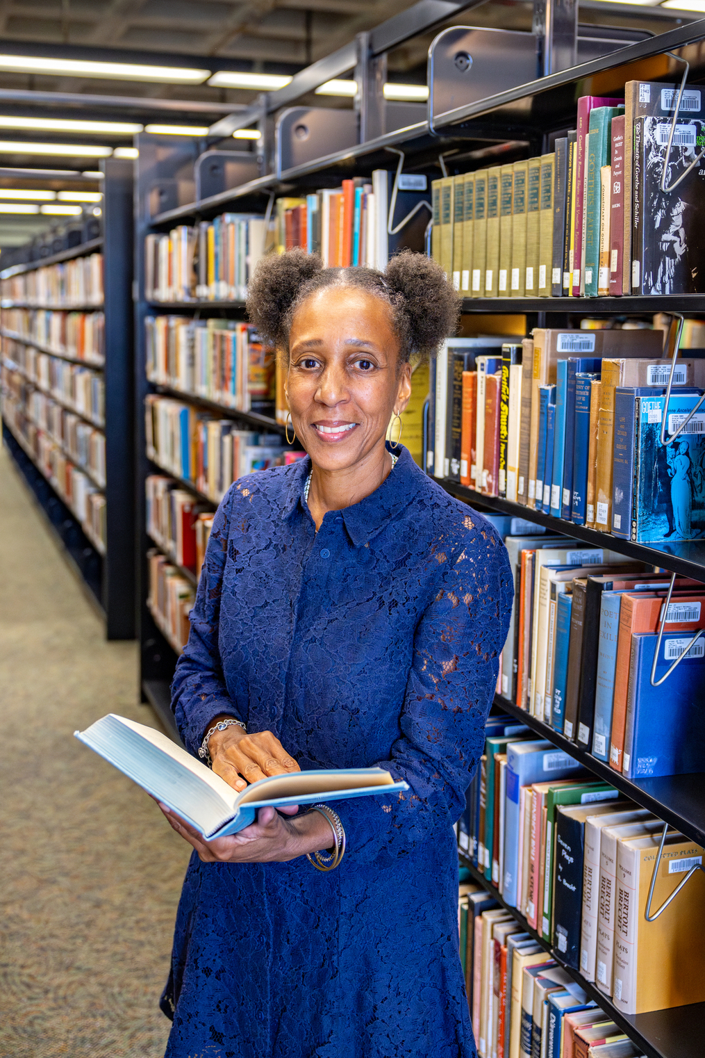 Dr. Sekai Turner holding a book in the library