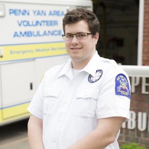 Jake Banas stands near an ambulance