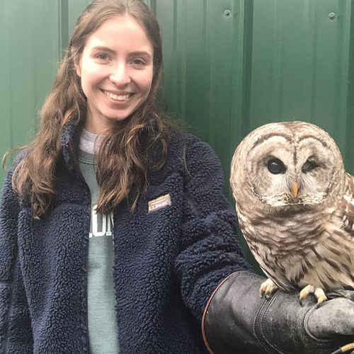 Grace Delrossa posing with an owl