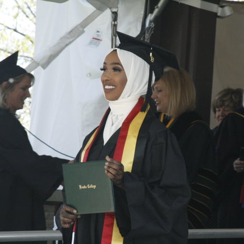 Hani Ali holding her diploma