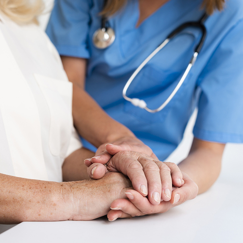 nurse holding a patient's hands